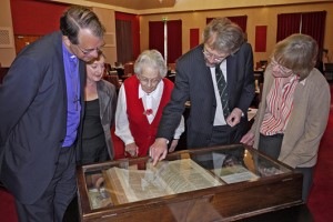 The Bishop and Thoroton Society officers viewing the bible in a glass case
