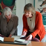 Janet Davies and Dorothy Johnston looking at manuscript