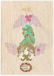 Valentine's Day card, 1860, depicting two figures painted green and gold, surrounded by flowers coloured white and pink. Addressed to a Miss Gardner, Leeds. (Ref: Ln2/2/6/9)