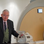 Sir Peter Mansfield with a MRI scanner