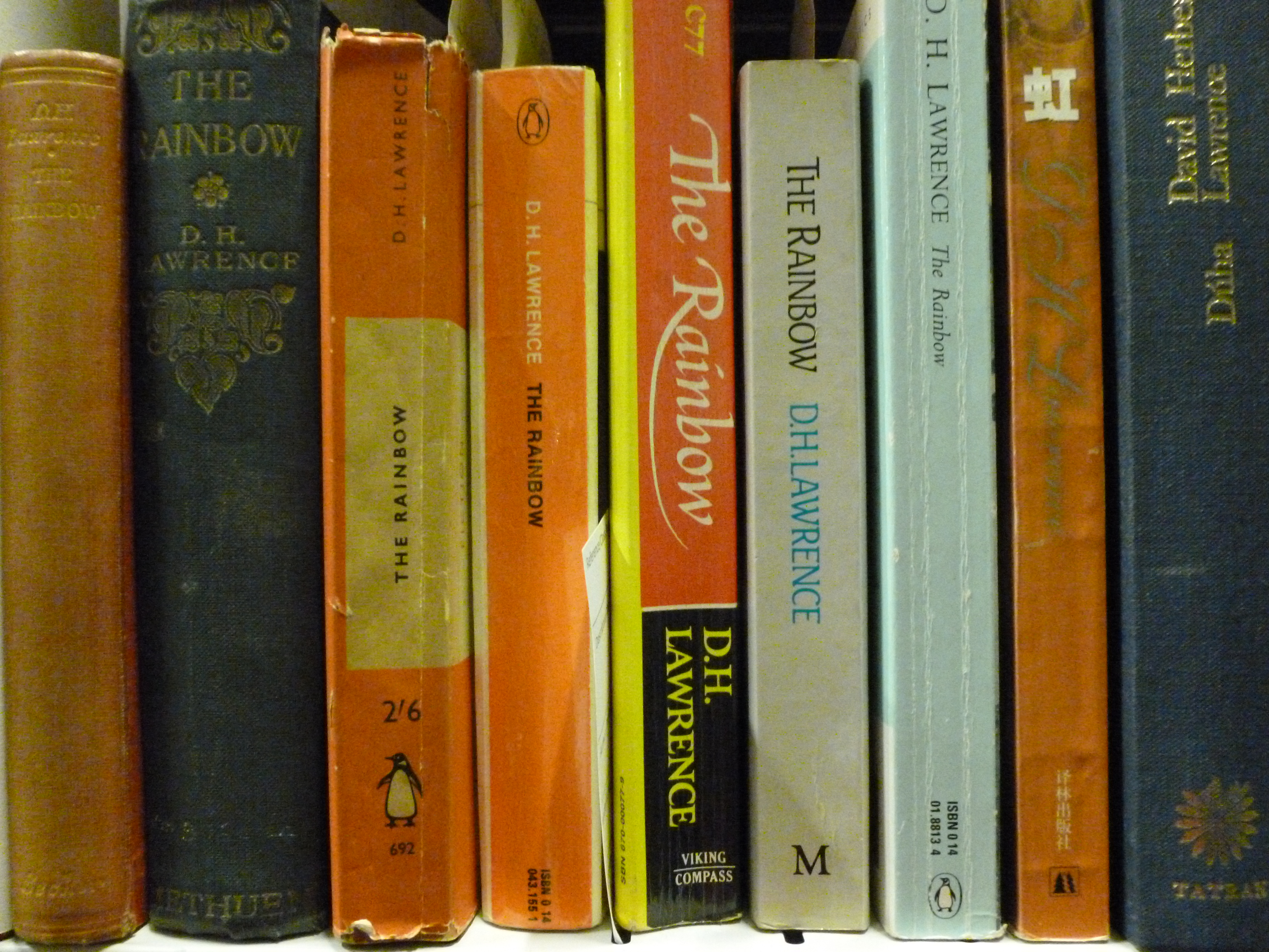 Copies of various editions of DH Lawrence's 'The Rainbow' on the shelves