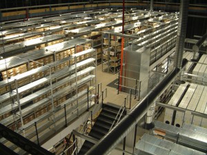 Photograph of the Manuscripts and Special Collections strong room from the second floor looking down at rows of metal shelves holding boxes