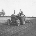 Agricultural students driving tractor, c.1948-1950