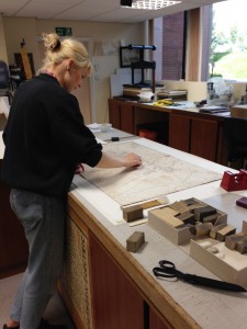 Kelly Grimshaw cleaning maps in Conservation, 2015