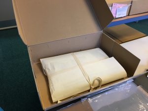 Bundle wrapped in archival paper in an archive box