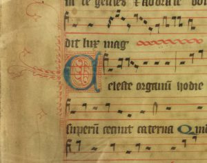 Medieval music showing the staves and words, with blue and red initial letters