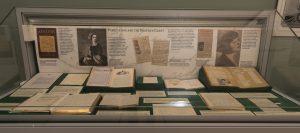 Photo of one of the cases in the Collected Words exhibition with a range of papers and books on display
