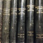 Photograph of the spines of bound minutes of University College Nottingham