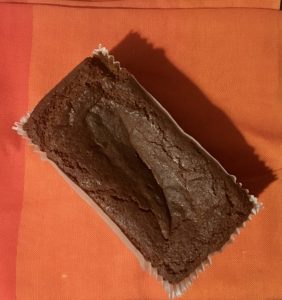 Photo of the gingerbread cake from above, on an orange tablecloth