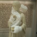 Small figurine of Florence Nightingale partially wrapped in tissue paper to protect her