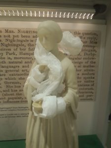 Small figurine of Florence Nightingale partially wrapped in tissue paper to protect her