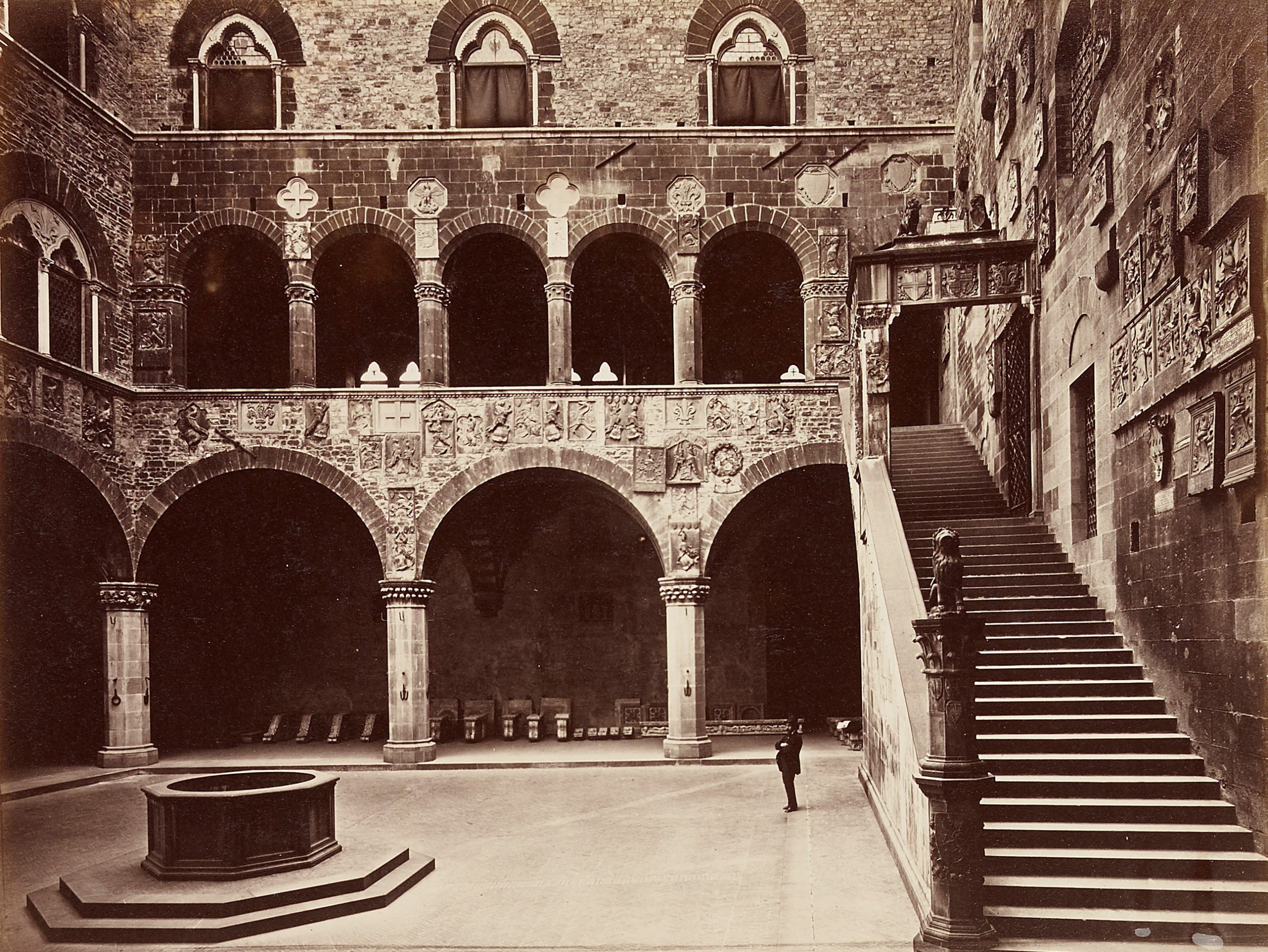 A sepia photograph of a courtyard and staircase at Palazzo Vecchio , Florence