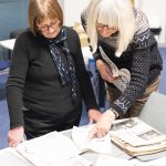 Photo of two women looking at feminist magazines