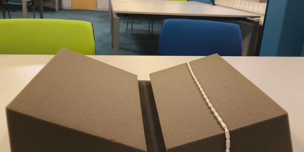 An example of a foam support and snake weight as used in the MSC Reading Room