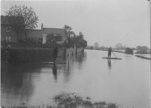 Black and white photographs of men on rafts on the flooded River Trent, Nottingham. 