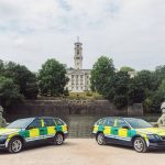 Two Community Responder vehicles in front of the lake and the Trent Building