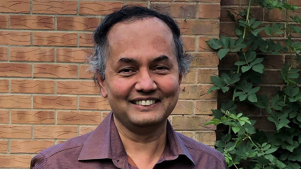 Professor Guruprasad Aithal smiling at the camera