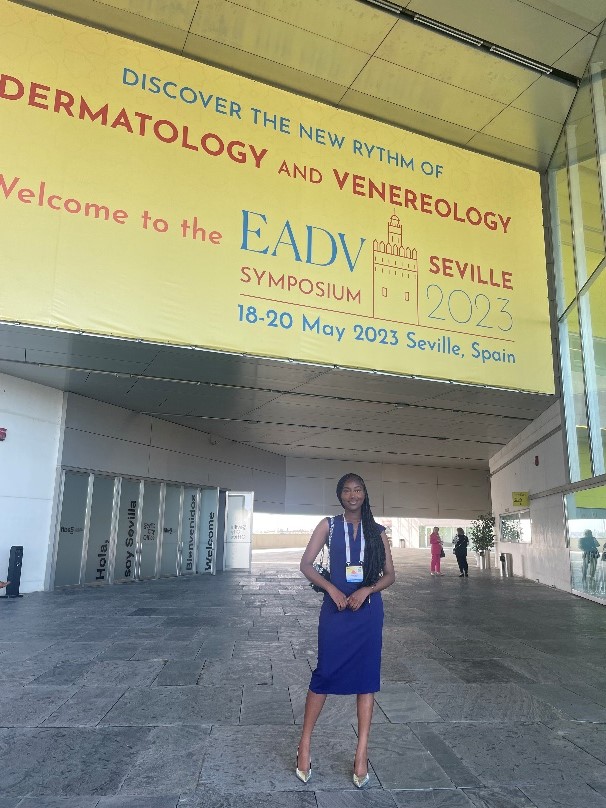 Rapid Eczema Trials Intern Natalie standing in front of the sign for the EADV Symposium