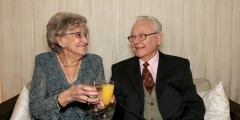Sir Peter and Lady Mansfield share a toast at the celebrations to mark Sir Peter's 80th birthday.