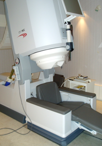 empty chair with large medical scanning instrument above