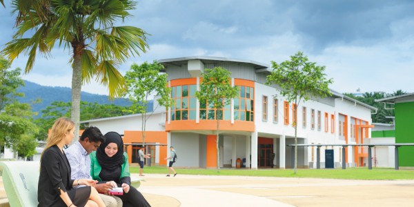 Male and female postgraduate students outside the business school, Malaysia Campus
