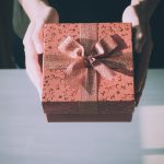 Close up of woman hands holding red gift box for special event
