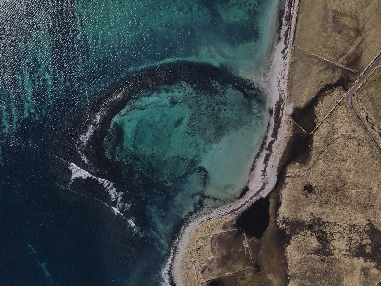 Aerial view of Weelie's Taing, Papa Westray, showing a tidal pool shore feature. Image courtesy and Copyright of Jonathan Ford.