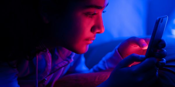Young girl using smartphone at night