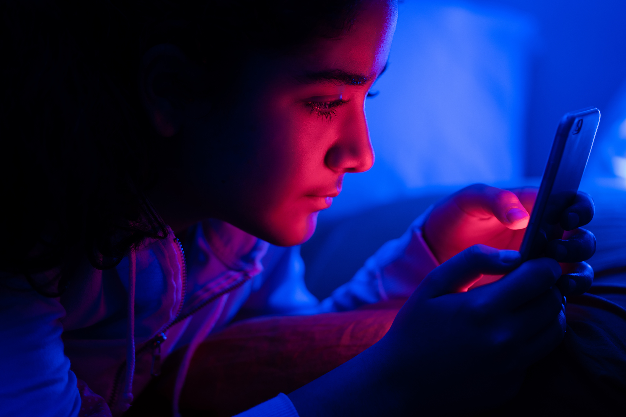 Young girl using smartphone at night