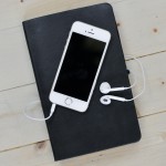 Favourite apps - A phone and headphones on top of a notebook