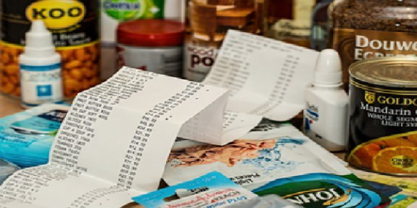 How to budget in the Kitchen - food shopping receipt surrounded by various food goods