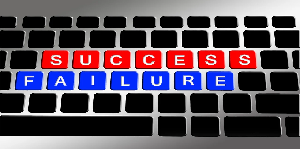 success and failure highlighted on a computer keyboard