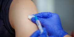 A person recieing a vaccine in their shoulder
