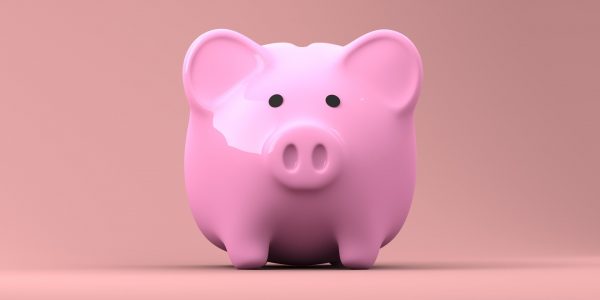a pink piggy bank with plain background