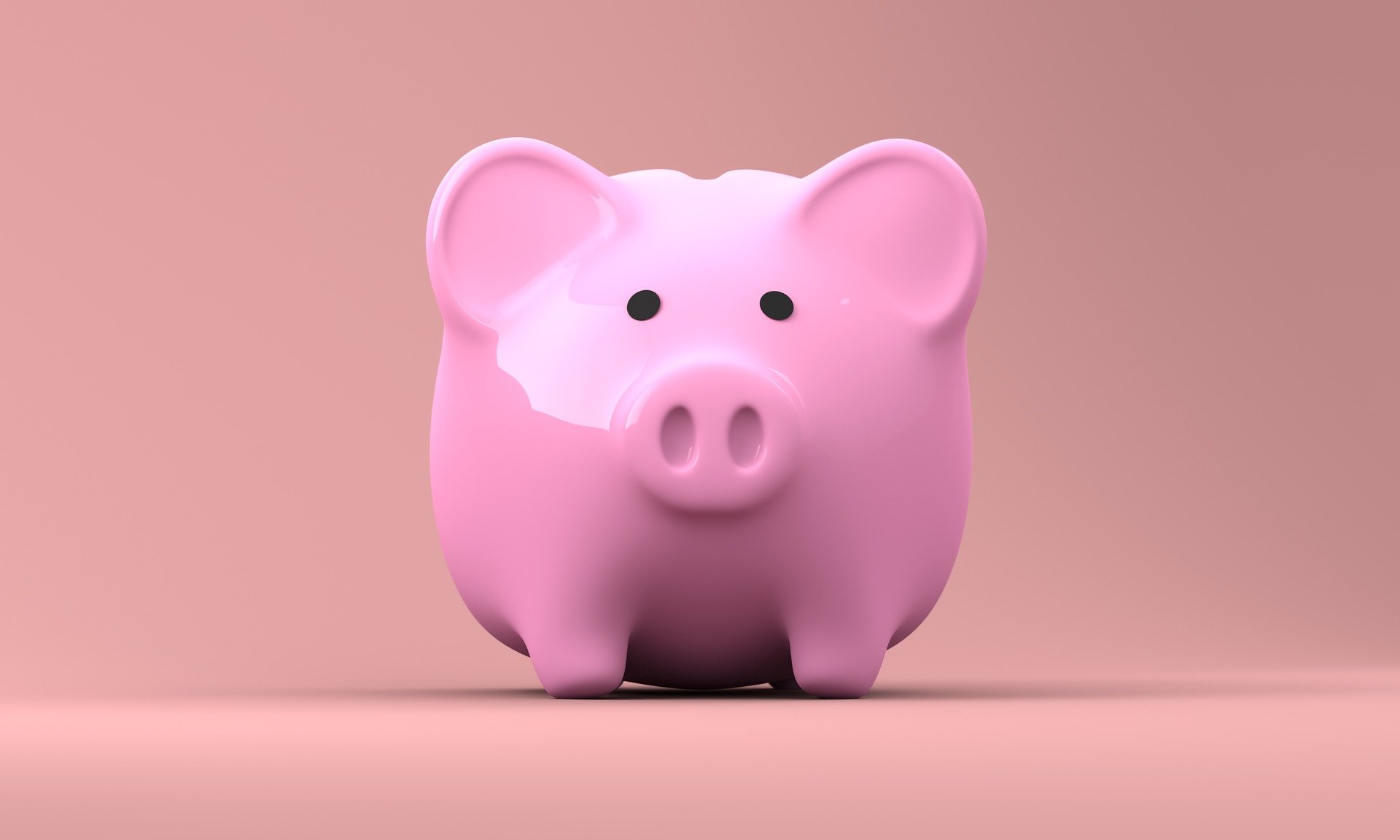 a pink piggy bank with plain background