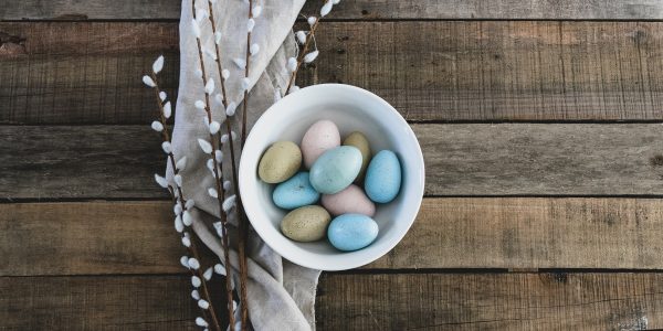 Colourful easter eggs in a bowl left on a wooden floor