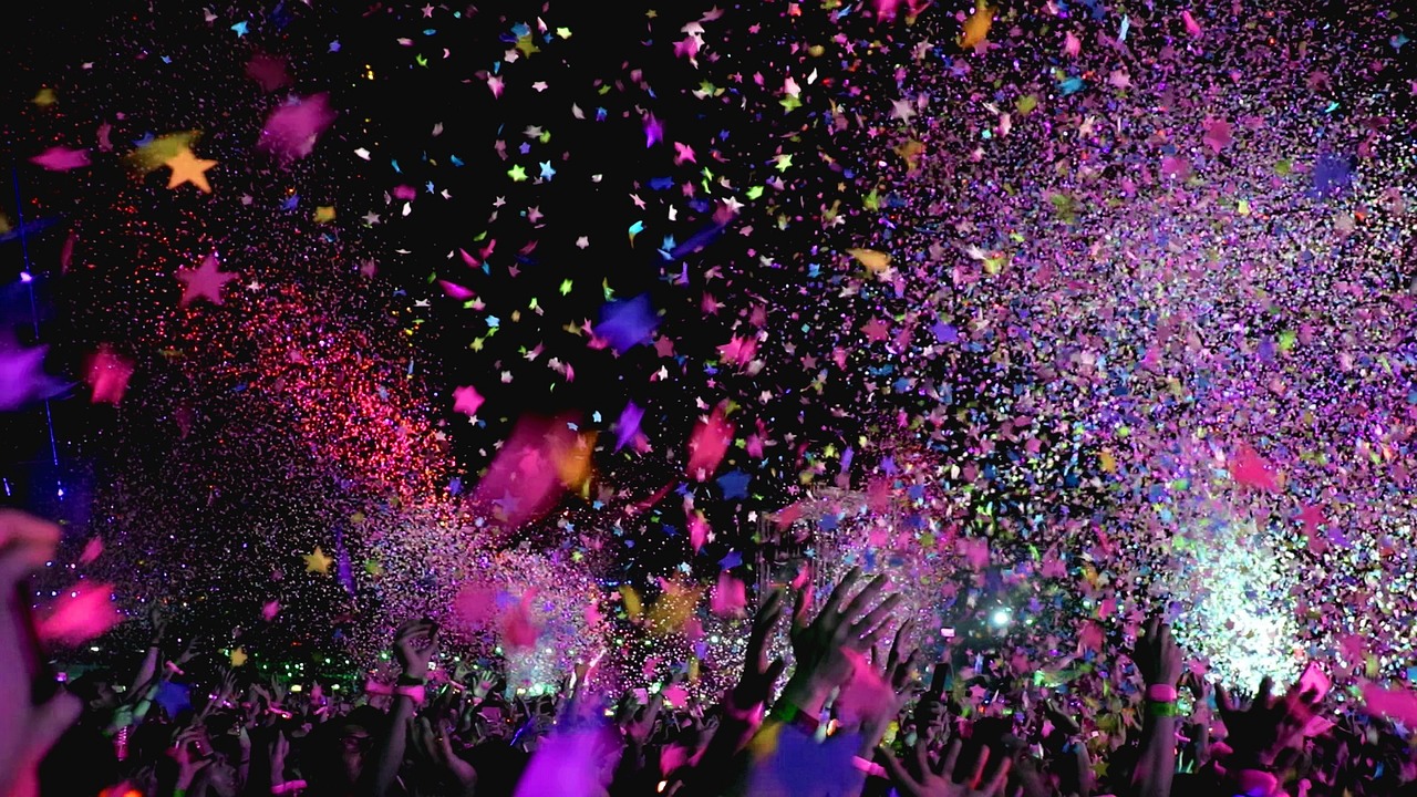 Confetti falling from the sky at a concert.