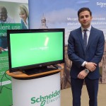 Majid Zeighami with Schneider Electric promotional display