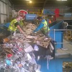 Wastecycle staff hand sorting waste
