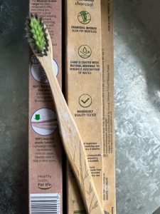 A bamboo toothbrush on recyclable packaging