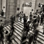 A blurred image of people walking up a steps.