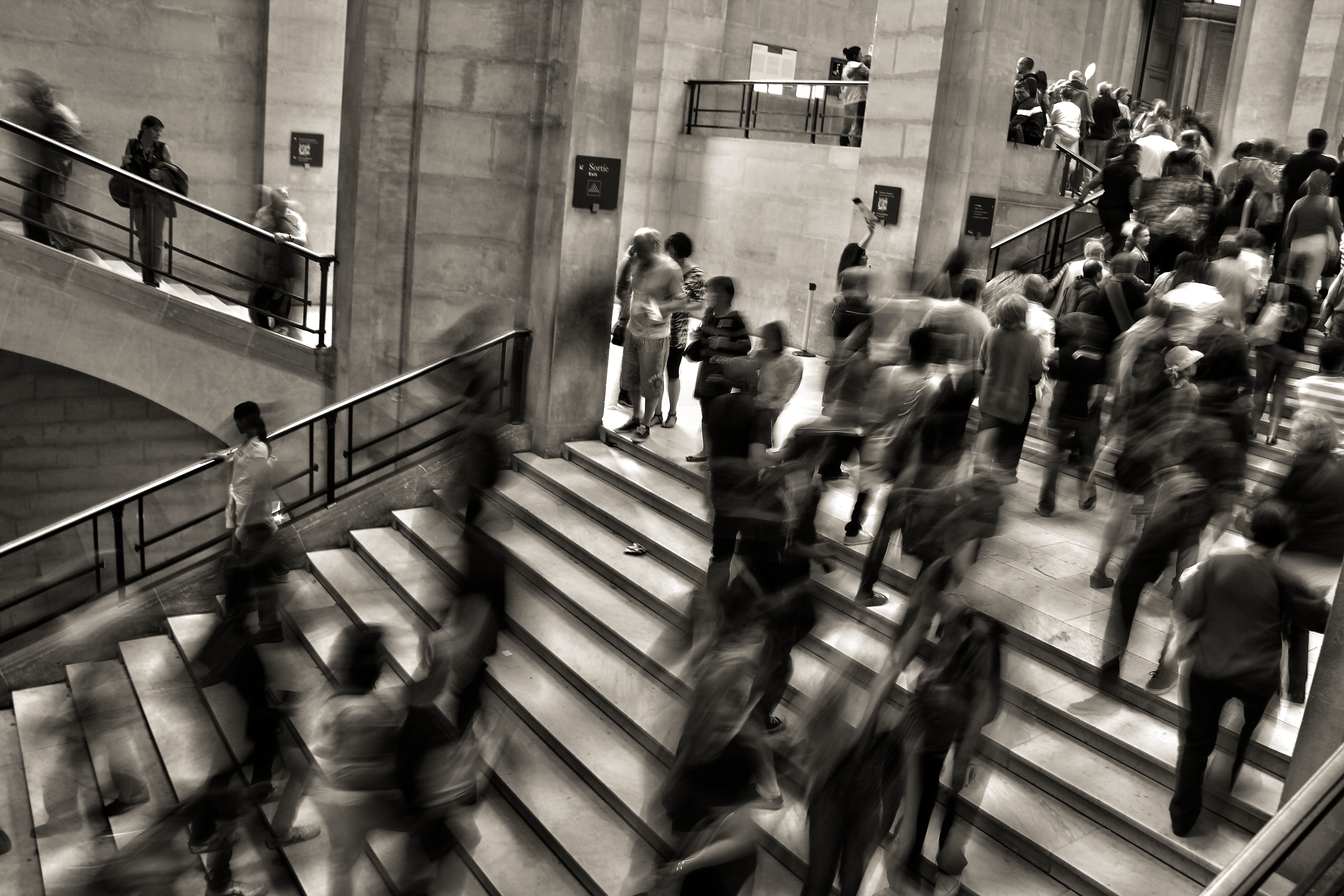 A blurred image of people walking up a steps.