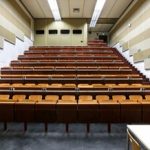Image of a lecture hall. All of the seats are empty.