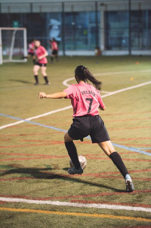 A girl playing football