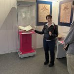 Dr Christina Lee points to an ancient manuscript as she gives a gallery tour