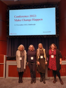 Rebecca and others standing on stage presenting at the Museums Association Conference